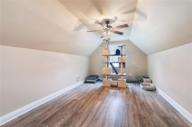 additional living space featuring baseboards, ceiling fan, wood finished floors, and lofted ceiling