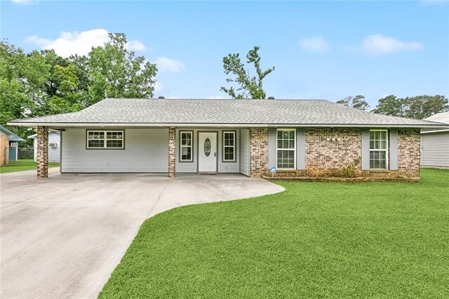 8752 Leisure Dr, Denham Springs, LA 70726 - ranch-style house featuring roof with shingles, concrete driveway, a front lawn, and brick siding