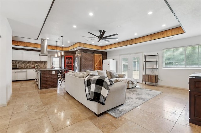 8752 Leisure Dr, Denham Springs, LA 70726 - living room with recessed lighting, a tray ceiling, and a wealth of natural light