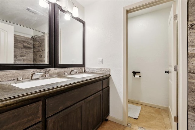 8752 Leisure Dr, Denham Springs, LA 70726 - full bathroom featuring visible vents, a sink, a shower, and double vanity