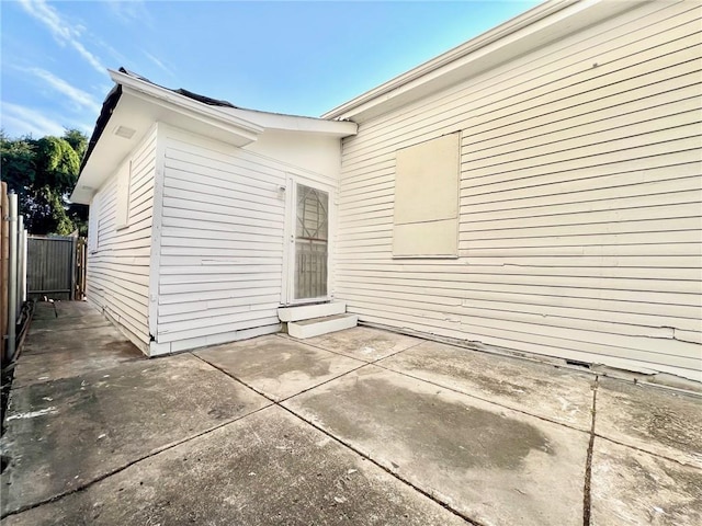 rear view of property featuring a patio area and fence