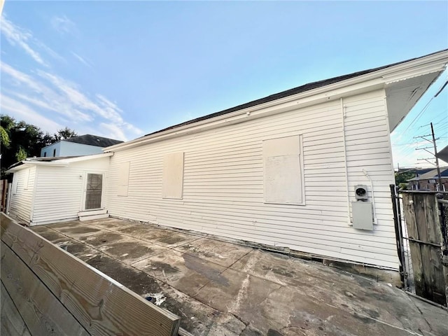 view of side of property featuring fence and a patio area