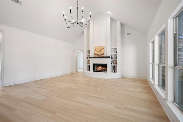 unfurnished living room featuring high vaulted ceiling, a notable chandelier, visible vents, and a fireplace