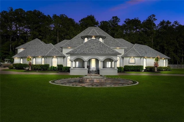 30222 N Dixie Ranch Rd, Lacombe, LA 70445 - french country home with a front lawn, a shingled roof, and stucco siding