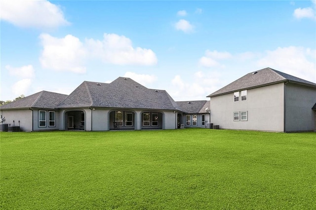 30222 N Dixie Ranch Rd, Lacombe, LA 70445 - back of property with stucco siding, a lawn, central AC, and a shingled roof