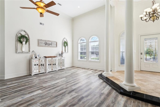 30222 N Dixie Ranch Rd, Lacombe, LA 70445 - foyer with decorative columns, a towering ceiling, crown molding, a ceiling fan, and baseboards