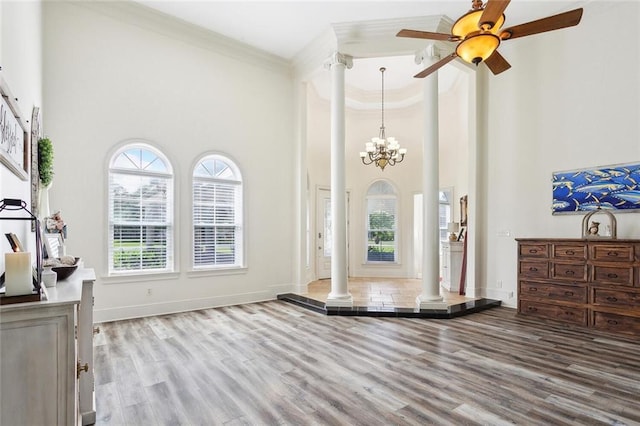 30222 N Dixie Ranch Rd, Lacombe, LA 70445 - foyer entrance with decorative columns, a high ceiling, crown molding, wood finished floors, and baseboards