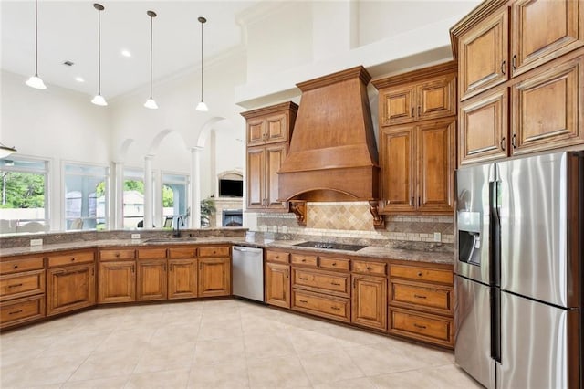 30222 N Dixie Ranch Rd, Lacombe, LA 70445 - kitchen featuring stainless steel appliances, brown cabinetry, premium range hood, a sink, and crown molding