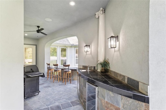 30222 N Dixie Ranch Rd, Lacombe, LA 70445 - kitchen featuring wine cooler, arched walkways, recessed lighting, ceiling fan, and a sink