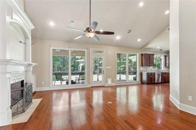 unfurnished living room featuring ceiling fan, visible vents, baseboards, and wood finished floors