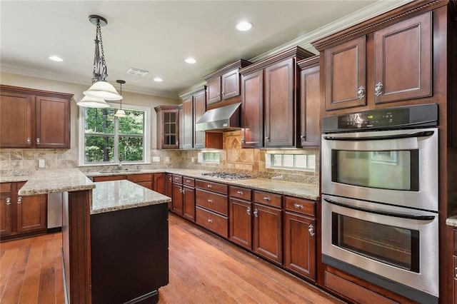 kitchen with exhaust hood, crown molding, light stone counters, light wood finished floors, and stainless steel appliances