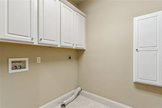 laundry area with tile patterned flooring, baseboards, hookup for a washing machine, electric dryer hookup, and cabinet space