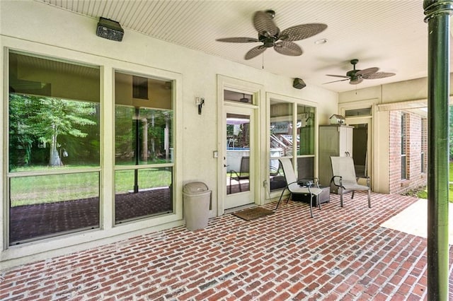 sunroom / solarium featuring a ceiling fan