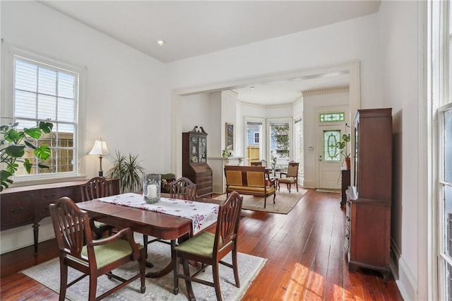 dining space with a healthy amount of sunlight and hardwood / wood-style floors