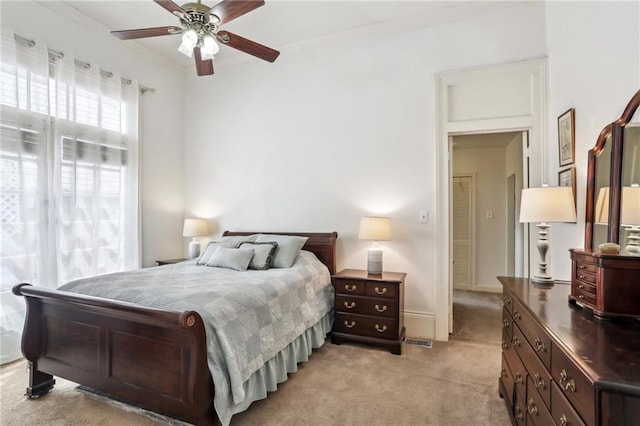 bedroom featuring crown molding, ceiling fan, and light colored carpet