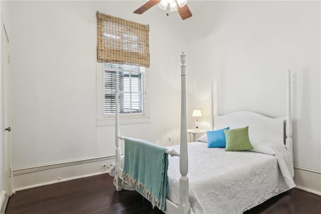 bedroom with baseboards, ceiling fan, and wood finished floors
