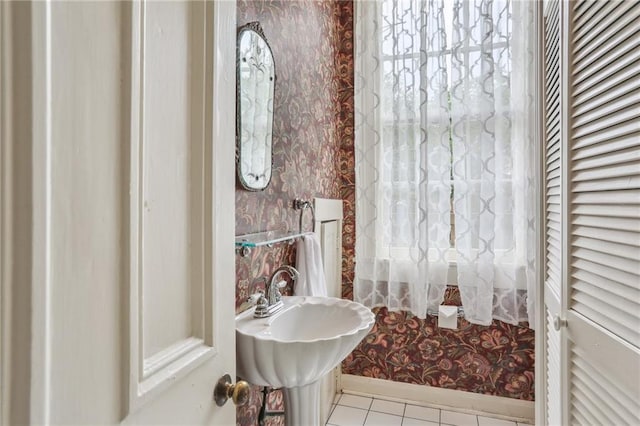 bathroom featuring tile patterned floors, baseboards, and wallpapered walls