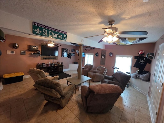 living area featuring a ceiling fan and a textured ceiling