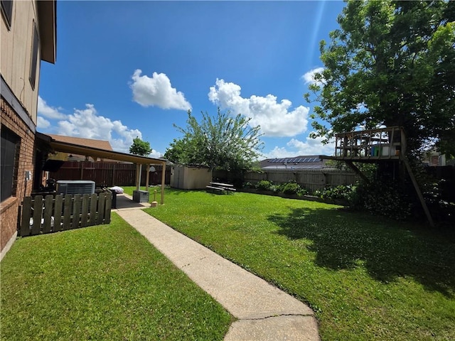 view of yard featuring a fenced backyard, an outbuilding, a patio, and a storage shed