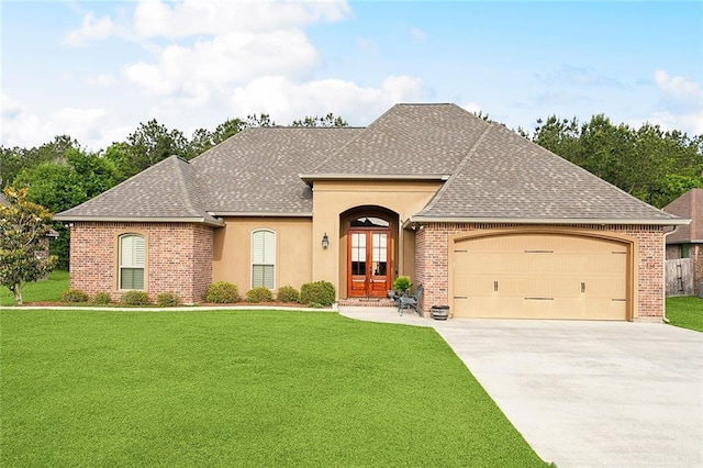 french country style house featuring a garage, a front yard, french doors, a shingled roof, and concrete driveway