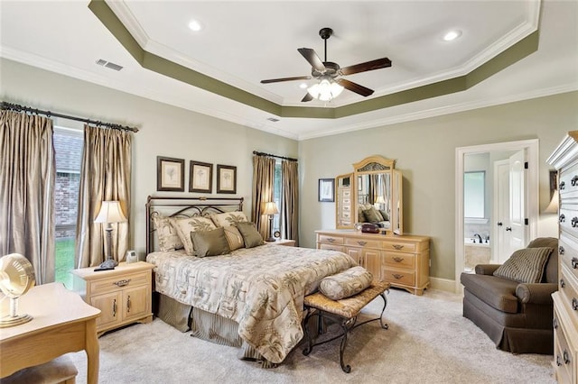 bedroom with visible vents, a raised ceiling, crown molding, and light colored carpet