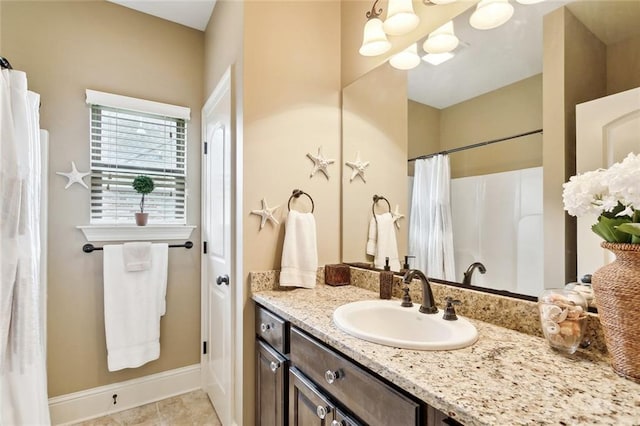 bathroom with tile patterned flooring, vanity, baseboards, a chandelier, and a shower with curtain