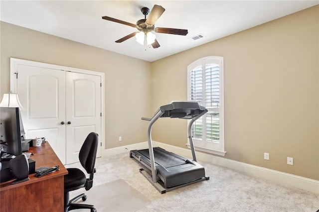 office space with carpet floors, baseboards, a ceiling fan, and visible vents