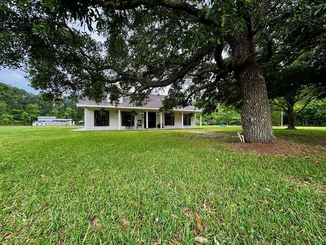 back of house with a yard