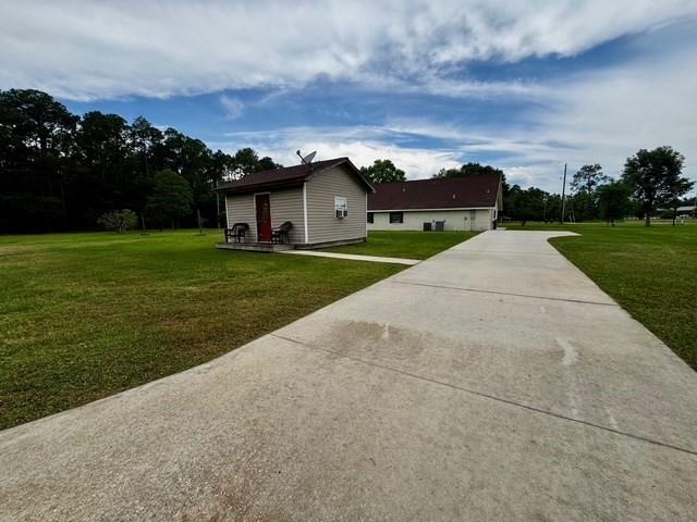 view of home's exterior featuring a lawn and driveway