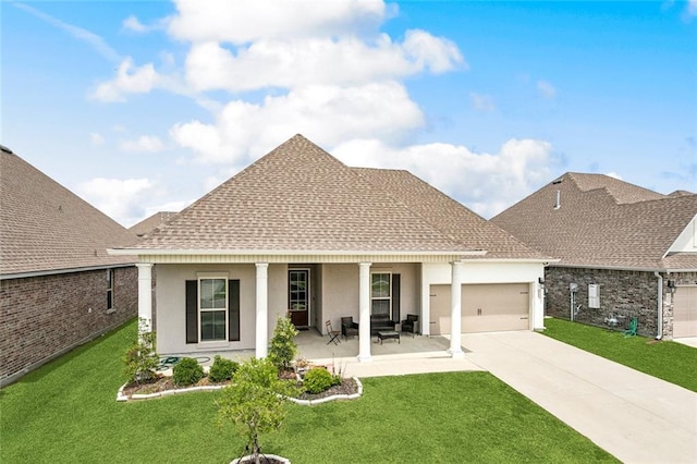 back of property with driveway, a garage, a yard, a shingled roof, and stucco siding