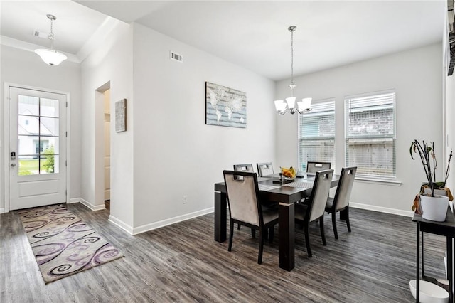 dining area with baseboards, dark wood-style flooring, a chandelier, and a healthy amount of sunlight