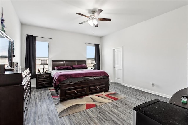 bedroom with baseboards, a ceiling fan, and wood finished floors
