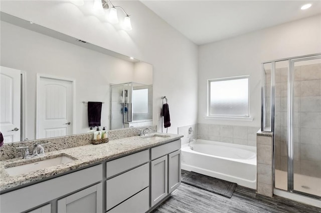 full bath featuring a sink, a bath, and a stall shower