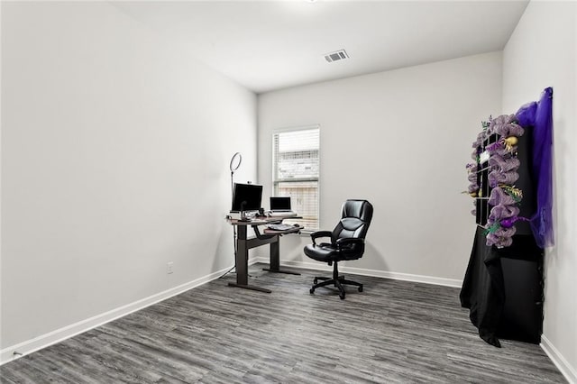 office space with baseboards, wood finished floors, and visible vents