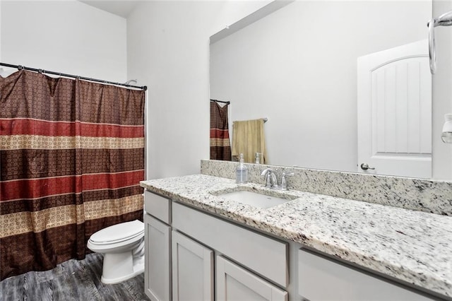 full bathroom featuring vanity, wood finished floors, toilet, and a shower with curtain