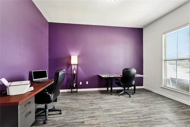 home office featuring baseboards, plenty of natural light, and wood finished floors