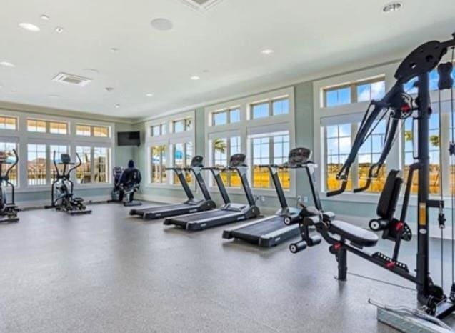 gym with crown molding and recessed lighting