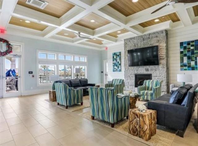 living room with visible vents, recessed lighting, coffered ceiling, and a stone fireplace