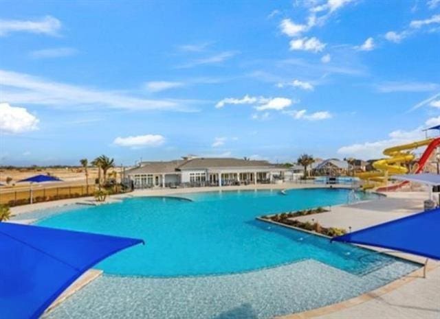 community pool featuring fence and a patio