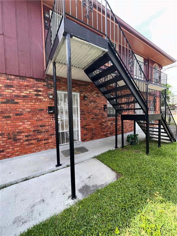 exterior space featuring a patio and brick siding
