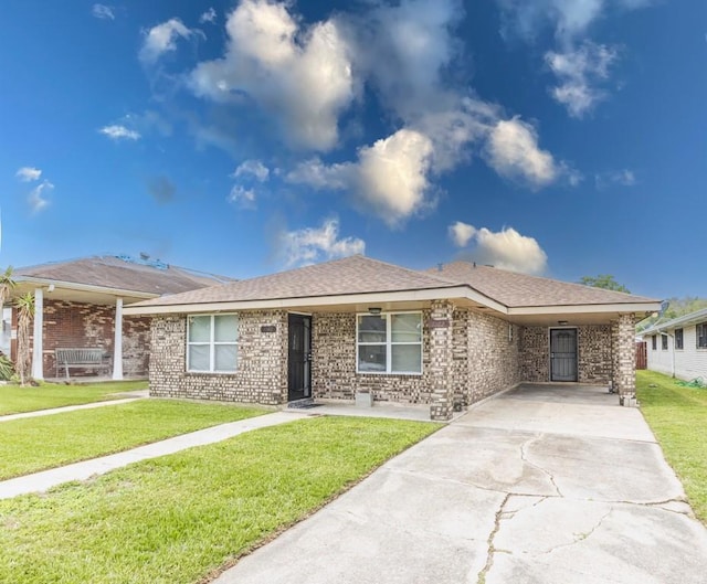 single story home featuring concrete driveway, a front lawn, and brick siding