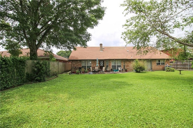 4525 Craig Ave, Metairie, LA 70003 - rear view of property with a lawn, a fenced backyard, a patio area, and brick siding