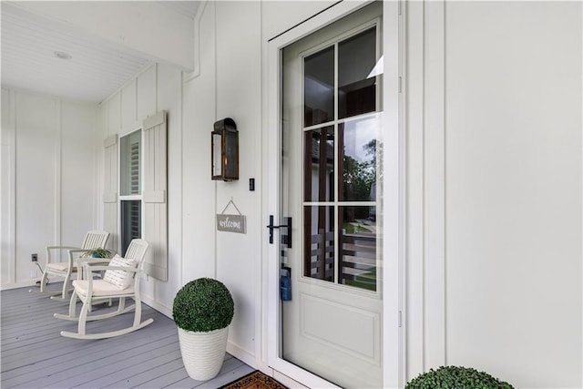 property entrance with a porch and board and batten siding