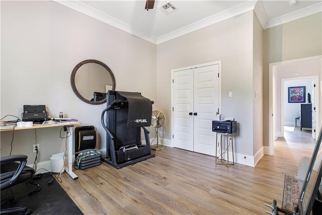 office with crown molding, baseboards, visible vents, and wood finished floors