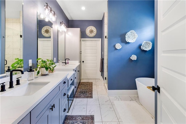 bathroom with a freestanding bath, a sink, double vanity, marble finish floor, and a stall shower