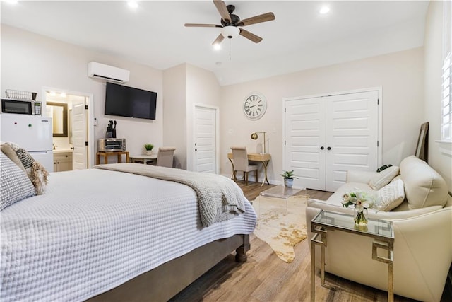 bedroom with a closet, wood finished floors, ceiling fan, recessed lighting, and a wall mounted AC