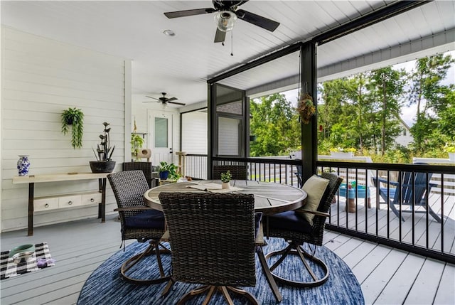 wooden deck featuring ceiling fan and outdoor dining area