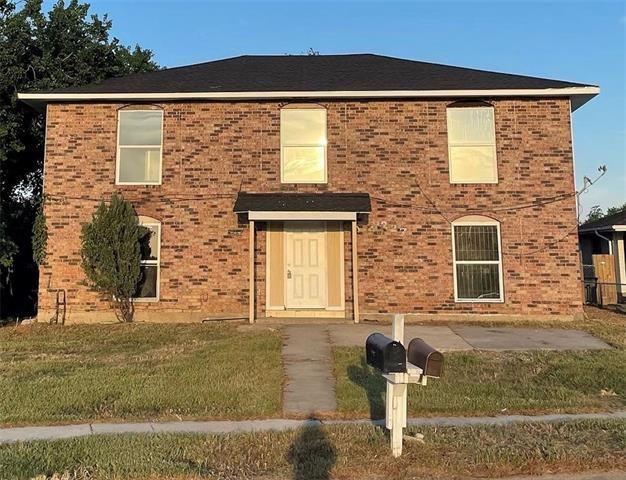 5227-5229 Cannes St, New Orleans, LA 70129 - view of front facade with brick siding and a front yard