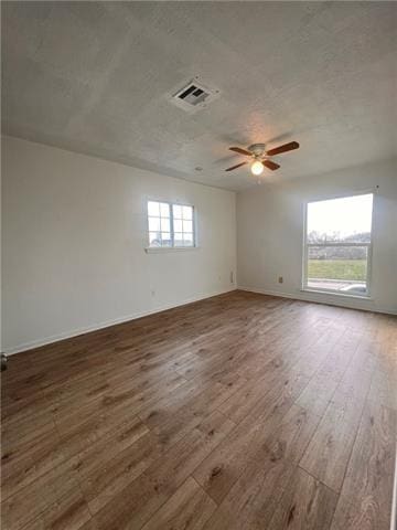 5227-5229 Cannes St, New Orleans, LA 70129 - unfurnished room featuring baseboards, ceiling fan, wood finished floors, and visible vents