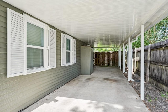 view of patio with fence and an attached carport
